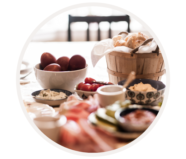 Nahaufnahme eines gedeckten Frühstückstisches mit Eiern, Brotkorb und verschiedenen Aufstrichen