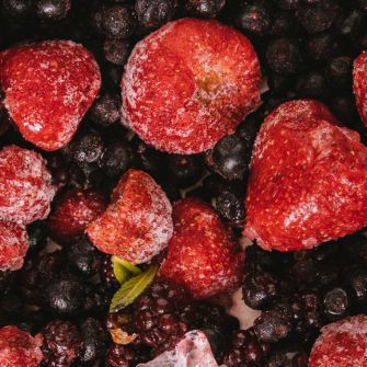 Nahaufnahme einer gefrorenen Beerenmischung mit Erdbeeren, Heidelbeeren und Brombeeren