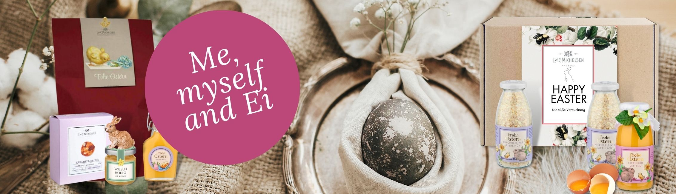 Oster-Geschenkset mit Honig, Likör und Süßigkeiten von L.W.C. Michelsen, verziert mit Osterdekoration und Text 'Me, myself and Ei'.